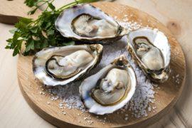 A,Photo,Of,Oysters,On,A,Wooden,Cutting,Board